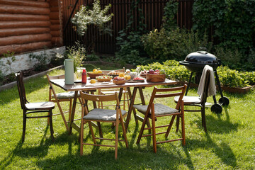 Setting Outdoor Summer Picnic Table with Fresh Fruits