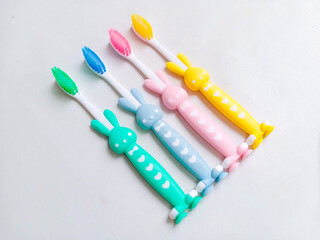 Close up of colorful kid tooth brush on white background. Cute bunny tooth brush for children on white background