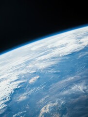 A breathtaking view of Earth from space, showcasing the planet's blue oceans, white clouds, and curvature against the blackness of the universe.