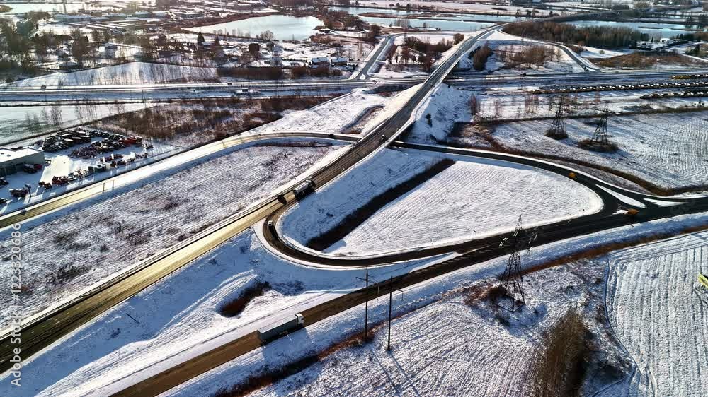 Aufkleber a snowy highway intersection captured from above with smooth motion timelapse mood