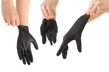 Woman puts on black rubber gloves.