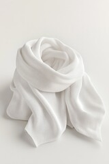 Obraz premium A single white scarf lying flat on a table surface