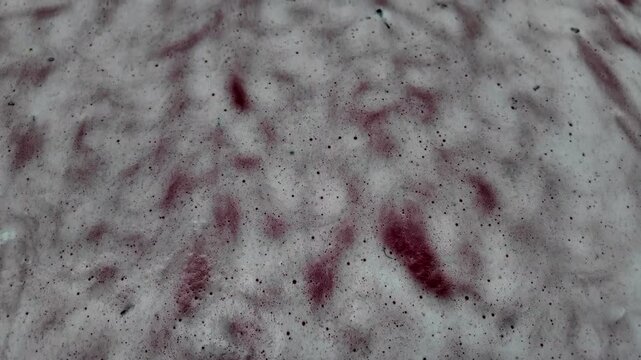 Handheld shot of reddish spots and dark dots strange pattern