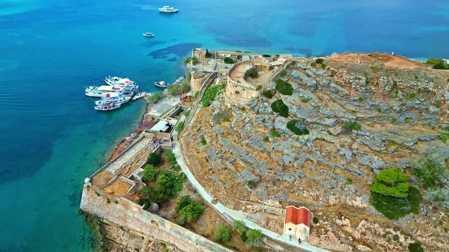 Parallax drone shot of Spinalonga fortress with blue water in Crete, Greece