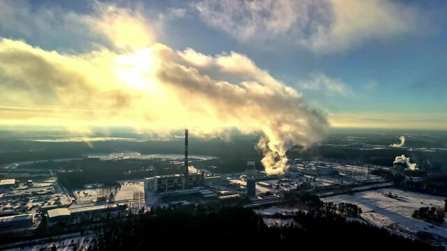 Sunny winter day and massive power plant, aerial view