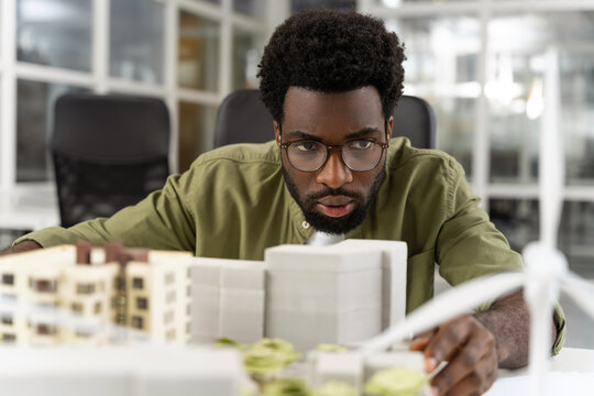 Young african american architect looking concentrated while working on a project
