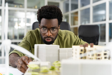 Young african american architect looking concentrated while working on a project