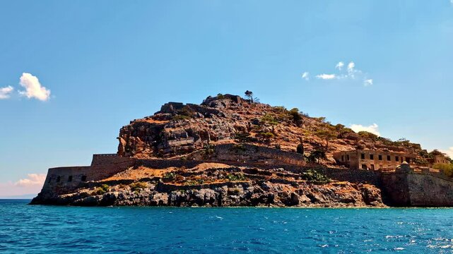View from the water to the island of Spinalonga with the ruins of the fortress.