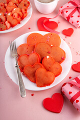 Sweet cute sign of love on Valentine's Day, lovely breakfast, snack with red velvet pancakes in form of hearts, with sugar sprinkled hearts and berry. Simple food idea for Valentine's Day surprise gif