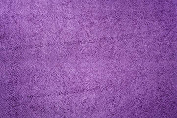 Purple suede as a background. Macro photo of the texture of natural dyed purple suede leather