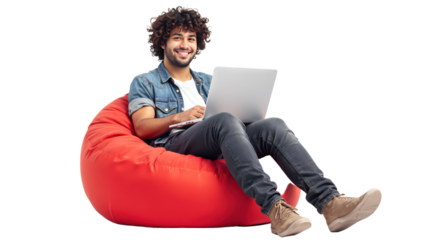 Young man sitting comfortably on a red bean bag, using a laptop on white or transparent background.