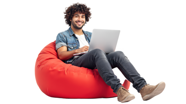 Young man sitting comfortably on a red bean bag, using a laptop on white or transparent background.