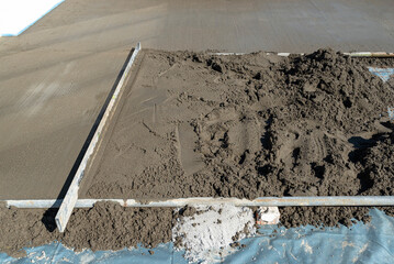 Pouring handmade concrete on to a home terrace covered with reinforcement.
