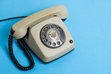 Vintage telephone on blue background with copy space for your text.