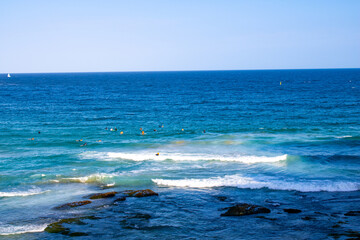 Stunning view of Bondi Beach in Sydney, Australia. Crystal-clear ocean waters with gentle waves lapping against the shore. Perfect for showcasing coastal beauty and serene seascapes.