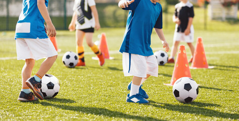 Soccer School for Kids. Football Acadaemy Practice Class. Group of Children Kicking Soccer Balls in Training Session. Kids Dribbling Soccer Balls Between Training Cones