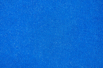 texture of the ground surface of a blue paddle tennis court, textured background