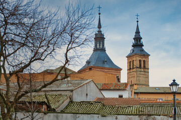 Obraz premium Towers of the Church of Our Lady of the Assumption of Navalcarnero, Madrid (Spain), rising above the rooftops.