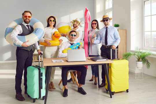 Working in office, business coworkers transition from work to vacation mode, with inflatable rings and suitcases. The team eagerly anticipates a holiday full of beach vibes and summer adventures.