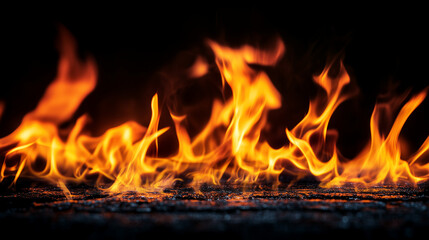 Fototapeta premium In a slow-motion sequence, flames burn steadily against a dark background, allowing the fluid movements and changing colors of the fire to be captured in stunning detail. The contr