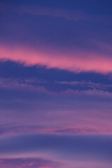 Pastel sunset hues paint the evening sky with soft pink and purple clouds
