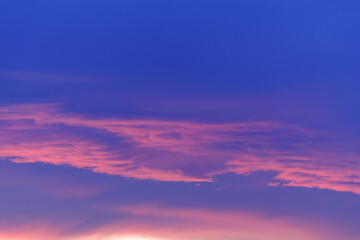 Pink and purple hues paint the evening sky a breathtaking sunset spectacle