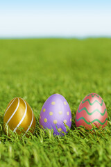 Colorful easter eggs resting on green grass. 3d rendering