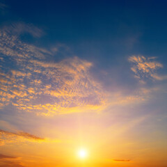 Beautiful sunset with bright sun and blue sky.