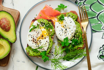 Whole grain toast with avocado and poached egg. for breakfast  .Healthy appetizer.