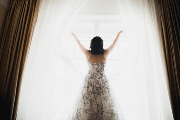 Beautiful bride wearing fashion wedding dress with feathers with luxury delight make-up and hairstyle, studio indoor photo shoot