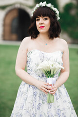 Portrait of stunning bride with long hair posing with great bouquet