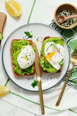 Whole grain toast with avocado and poached egg. for breakfast  .Healthy appetizer.