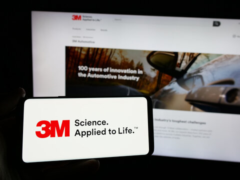 Stuttgart, Germany - 01-24-2025: Person holding smartphone with logo of US business 3M Company on screen in front of website. Focus on phone display.