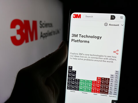Stuttgart, Germany - 01-24-2025: Person holding smartphone with webpage of US business 3M Company on screen in front of logo. Focus on center of phone display.