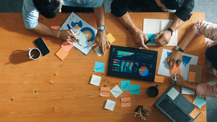 Executive manager explain financial graph to colleague at meeting room. Top aerial view of diverse...