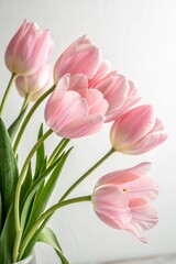 Fototapeta premium pink tulips in a vase, vertical image