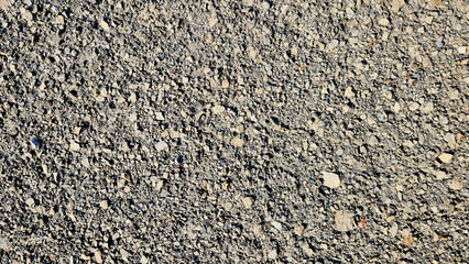 Texture. of grey gravel  surface of a rustic road 