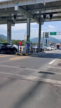 Car making highway toll payment at electronic booth