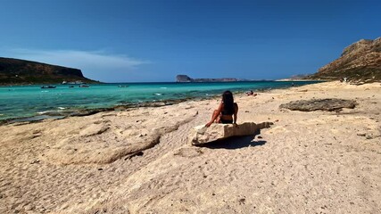 Beautiful beach woman relaxing in the sun, Crete island Greece holiday destination