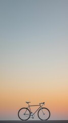 Obraz premium A lone bicycle frame against a clear sky, only the outline of the bike visible with a soft gradient background, emphasizing simplicity