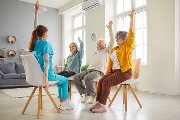 Nurse from reabilitation clinic shows physical exercises for mature people to maintain their health...