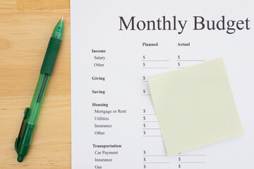 Monthly Budget Plan with Blank Sticky Note and Pen