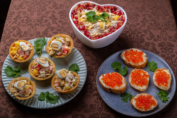 Salad with chicken, pineapple and pomegranate in a heart-shaped salad bowl