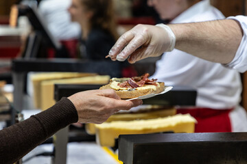 delicious wheel of raclette cheese has been heated on cutting edge.
