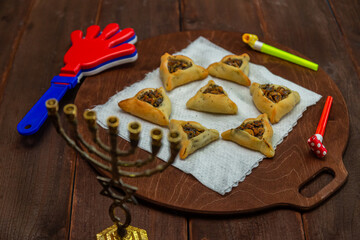 Sweet triangular gomentashi ears of Haman for the holiday of Purim on the table