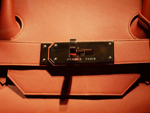 Luxury Hermes leather accessories : detail of handbag clasp with brand name