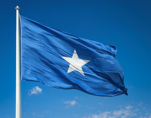 Flag of Somalia waving in the wind against a blue sky background