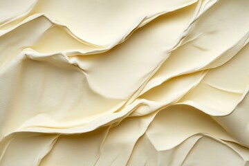 Creamy textured fabric folds, close-up, studio shot, background blur, design element