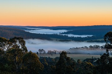 Obraz premium Serene Sunrise Over Foggy Valley Landscape