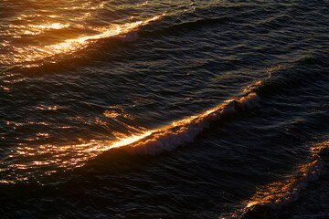 Photos of sea waves moving at sunset